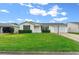 Single-story home with a well-maintained lawn and driveway at 7994 Se 174Th Belhaven Loop, The Villages, FL 32162