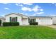 Well-maintained single story home featuring a two-car garage and manicured lawn at 7994 Se 174Th Belhaven Loop, The Villages, FL 32162