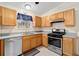 Clean kitchen featuring stainless steel appliances and wood cabinets at 7994 Se 174Th Belhaven Loop, The Villages, FL 32162