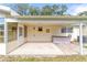 Back patio with hot tub, access door and covered area at 8420 Sw 93 Ln # E, Ocala, FL 34481