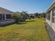 Spacious backyard showcasing multiple homes and lush grass at 8652 Se 133Rd Ln, Summerfield, FL 34491