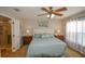 Main bedroom with ceiling fan, ensuite bathroom access and neutral decor at 8652 Se 133Rd Ln, Summerfield, FL 34491