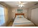 Bright bedroom with a queen-size bed and ceiling fan at 8652 Se 133Rd Ln, Summerfield, FL 34491