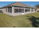 Rear view of house, highlighting screened patio and yard at 8652 Se 133Rd Ln, Summerfield, FL 34491