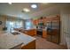 Modern kitchen with stainless steel appliances and wood cabinetry at 8652 Se 133Rd Ln, Summerfield, FL 34491