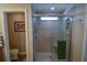 Walk-in shower with glass enclosure and built-in shelving at 8652 Se 133Rd Ln, Summerfield, FL 34491