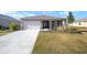 One-story house with a white garage door and a front yard at 8761 Sw 79Th Loop, Ocala, FL 34481