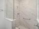 Walk-in shower with marble tile and glass enclosure at 8761 Sw 79Th Loop, Ocala, FL 34481