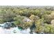 Aerial view of waterfront property with boat and lush vegetation at 9050 Sw 190Th Cir, Dunnellon, FL 34432