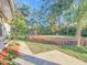 Landscaped backyard with mature trees and walkway at 9050 Sw 190Th Cir, Dunnellon, FL 34432