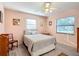 Bright bedroom with a double bed, ceiling fan, and wood-look floors at 9050 Sw 190Th Cir, Dunnellon, FL 34432