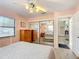 Spacious bedroom with mirrored closet doors and light pink walls at 9050 Sw 190Th Cir, Dunnellon, FL 34432