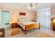 Serene bedroom featuring a double bed, light pink walls, and wood floors at 9050 Sw 190Th Cir, Dunnellon, FL 34432