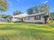 House showcasing clean lines and a well-maintained lawn at 9050 Sw 190Th Cir, Dunnellon, FL 34432