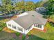 White house with gray roof, screened porch, and landscaping at 9050 Sw 190Th Cir, Dunnellon, FL 34432