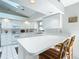 Modern kitchen with white cabinetry and breakfast bar at 9050 Sw 190Th Cir, Dunnellon, FL 34432