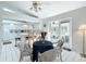 Kitchen with breakfast nook, white cabinets, and view to screened porch at 9050 Sw 190Th Cir, Dunnellon, FL 34432