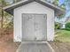 White storage shed with metal doors at 9050 Sw 190Th Cir, Dunnellon, FL 34432