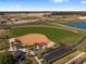 Aerial view of a community baseball field with parking and surrounding landscape at 9474 Sw 52Nd Loop, Ocala, FL 34481