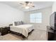 Spacious bedroom with a king-size bed and large window at 9474 Sw 52Nd Loop, Ocala, FL 34481