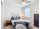 Guest bedroom with a full bed, nightstand, and ceiling fan at 9474 Sw 52Nd Loop, Ocala, FL 34481