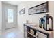 Bright entryway with decorative console table and elegant glass door at 9474 Sw 52Nd Loop, Ocala, FL 34481