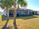 Backyard oasis with a screened patio and palm trees at 9474 Sw 52Nd Loop, Ocala, FL 34481