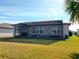 Home exterior showcasing a large screened patio and lush lawn at 9474 Sw 52Nd Loop, Ocala, FL 34481