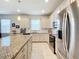 Modern kitchen with granite countertops and stainless steel appliances at 9474 Sw 52Nd Loop, Ocala, FL 34481