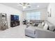 Relaxing living room featuring gray sectional sofa and wood shelving at 9474 Sw 52Nd Loop, Ocala, FL 34481