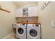 Laundry room with washer, dryer, and ample storage at 1111 Se 49Th Ave, Ocala, FL 34471