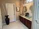 Double vanity bathroom with granite countertops and decorative mirrors at 13300 Se 97Th Terrace Rd, Summerfield, FL 34491