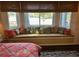 Bedroom with window seat, offering a peaceful golf course view at 13300 Se 97Th Terrace Rd, Summerfield, FL 34491