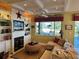 Cozy living room with a fireplace, built-in shelves, and golf course view at 13300 Se 97Th Terrace Rd, Summerfield, FL 34491