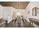 Bright dining room with a rustic wooden table and chandelier at 13740 Sw 49Th Pl, Ocala, FL 34481