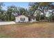 Single-story home with a spacious lawn and mature trees at 13740 Sw 49Th Pl, Ocala, FL 34481