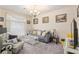 Cozy living room featuring a gray sofa and comfy armchair at 15092 Sw 14Th Avenue Rd, Ocala, FL 34473