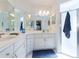 Double vanity bathroom with a large mirror and walk-in shower at 15440 Sw 14Th Avenue Rd, Ocala, FL 34473