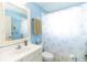 Clean bathroom with shower/tub combo, white vanity, and light blue walls at 15440 Sw 14Th Avenue Rd, Ocala, FL 34473