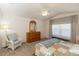 Bedroom with wooden dresser, ceiling fan, and window coverings at 15440 Sw 14Th Avenue Rd, Ocala, FL 34473