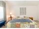 Bedroom featuring a comfy bed, wall decor, and a small side table at 15440 Sw 14Th Avenue Rd, Ocala, FL 34473