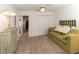 Guest bedroom with green sofa and access to hallway at 15440 Sw 14Th Avenue Rd, Ocala, FL 34473