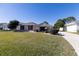 Tan one-story house with red shutters and a two-car garage at 15440 Sw 14Th Avenue Rd, Ocala, FL 34473