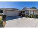 House exterior showcasing a two-car garage and neat landscaping at 15440 Sw 14Th Avenue Rd, Ocala, FL 34473