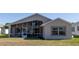 Tan house exterior with screened porch and yard at 15440 Sw 14Th Avenue Rd, Ocala, FL 34473