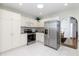 Modern kitchen with stainless steel appliances and white cabinets at 15440 Sw 14Th Avenue Rd, Ocala, FL 34473