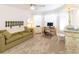 Home office with a green sofa, desk, and built-in shelving at 15440 Sw 14Th Avenue Rd, Ocala, FL 34473