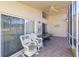 Relaxing screened porch with wicker chairs and ceiling fan at 15440 Sw 14Th Avenue Rd, Ocala, FL 34473