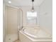 Bathroom with corner bathtub and shower at 15692 Sw 11Th Court Rd, Ocala, FL 34473