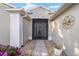 Front entry with a screened door and decorative compass at 15692 Sw 11Th Court Rd, Ocala, FL 34473